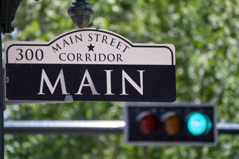 Main Street Sign with Traffic Light in the Background in Downtown Houston, Texas